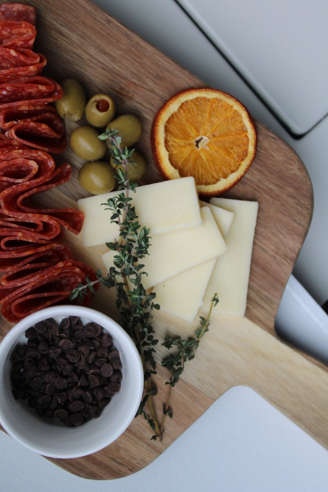 CURE-ATE charcuterie presentation featuring artisan cheeses, fruit and savory bites